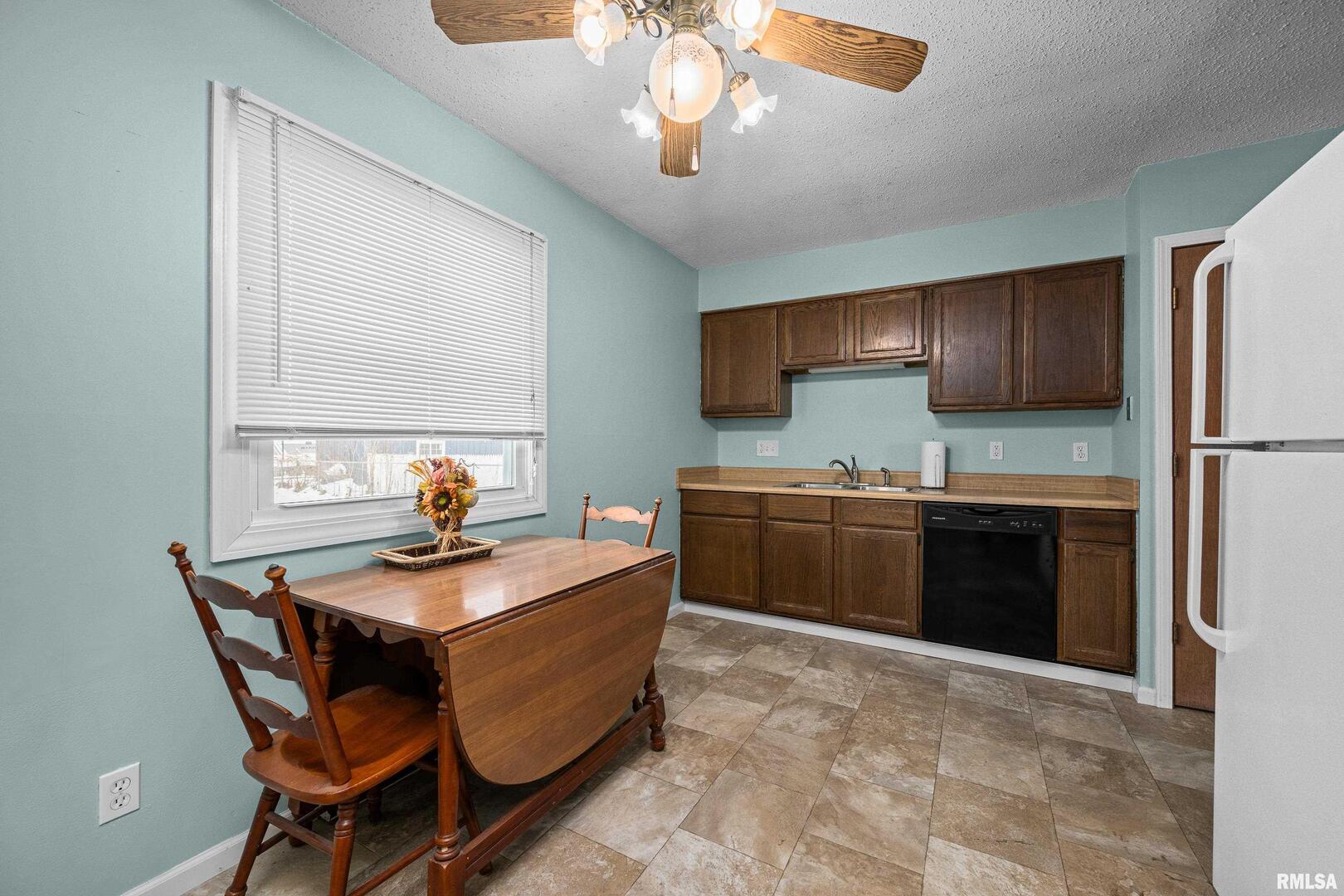 617 6th Street Camanche, IA 52730 - Photo 7 of 25 a kitchen with a stove a sink and a refrigerator