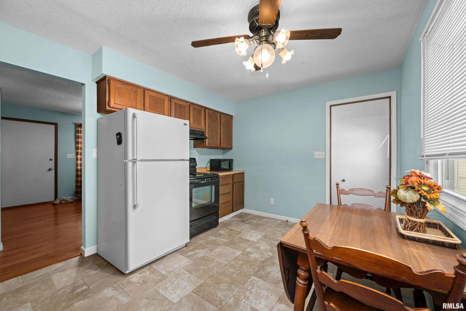 617 6th Street Camanche, IA 52730 - Photo 8 of 25 a kitchen with stainless steel appliances a refrigerator and a stove