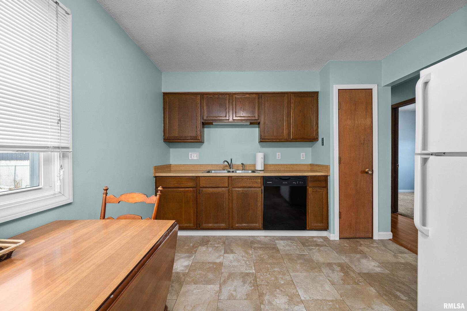 617 6th Street Camanche, IA 52730 - Photo 9 of 25 a kitchen with stainless steel appliances granite countertop a refrigerator and a stove top oven