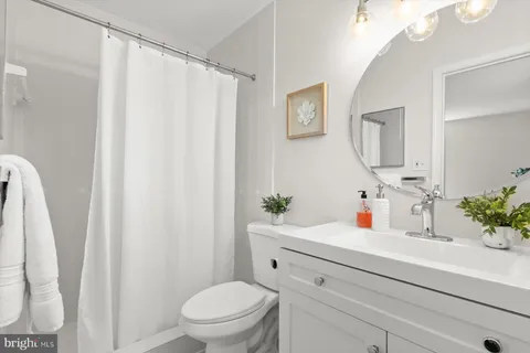 a bathroom with a sink a mirror and a toilet