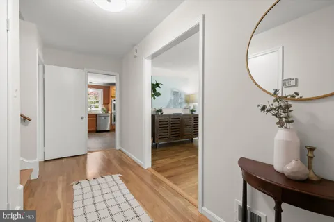 a bedroom with furniture and a mirror