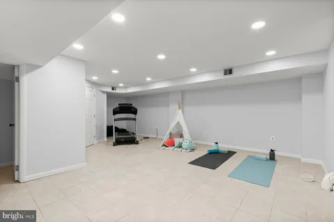 an empty room with air conditioner duct and materials on floor