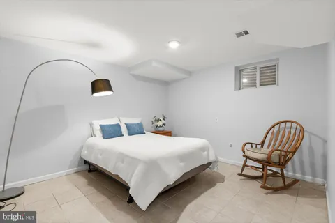 a bedroom with a bed and chair
