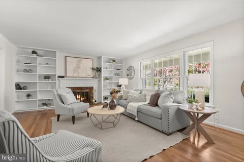 a living room with furniture a rug and a fireplace