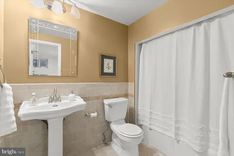 a bathroom with a sink toilet and mirror