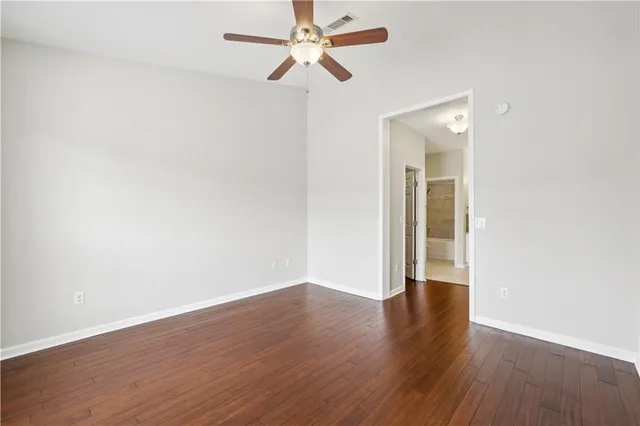 a bathroom with a granite countertop sink a mirror and a bathtub