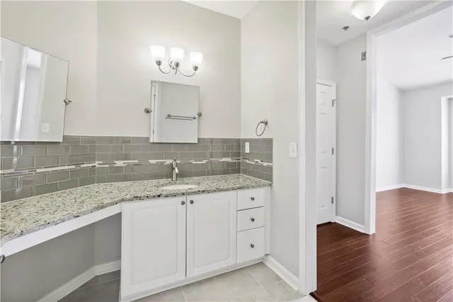 a white bath tub sitting next to a white toilet and a shower