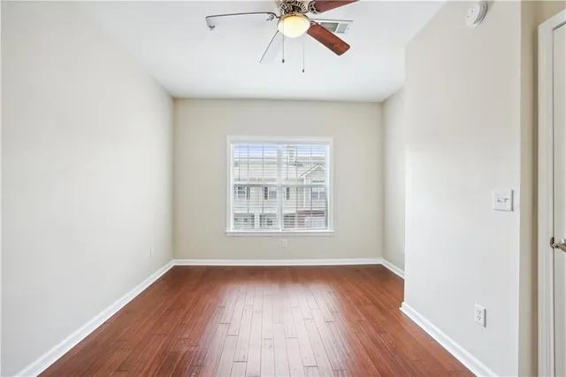 a view of an empty room with wooden floor