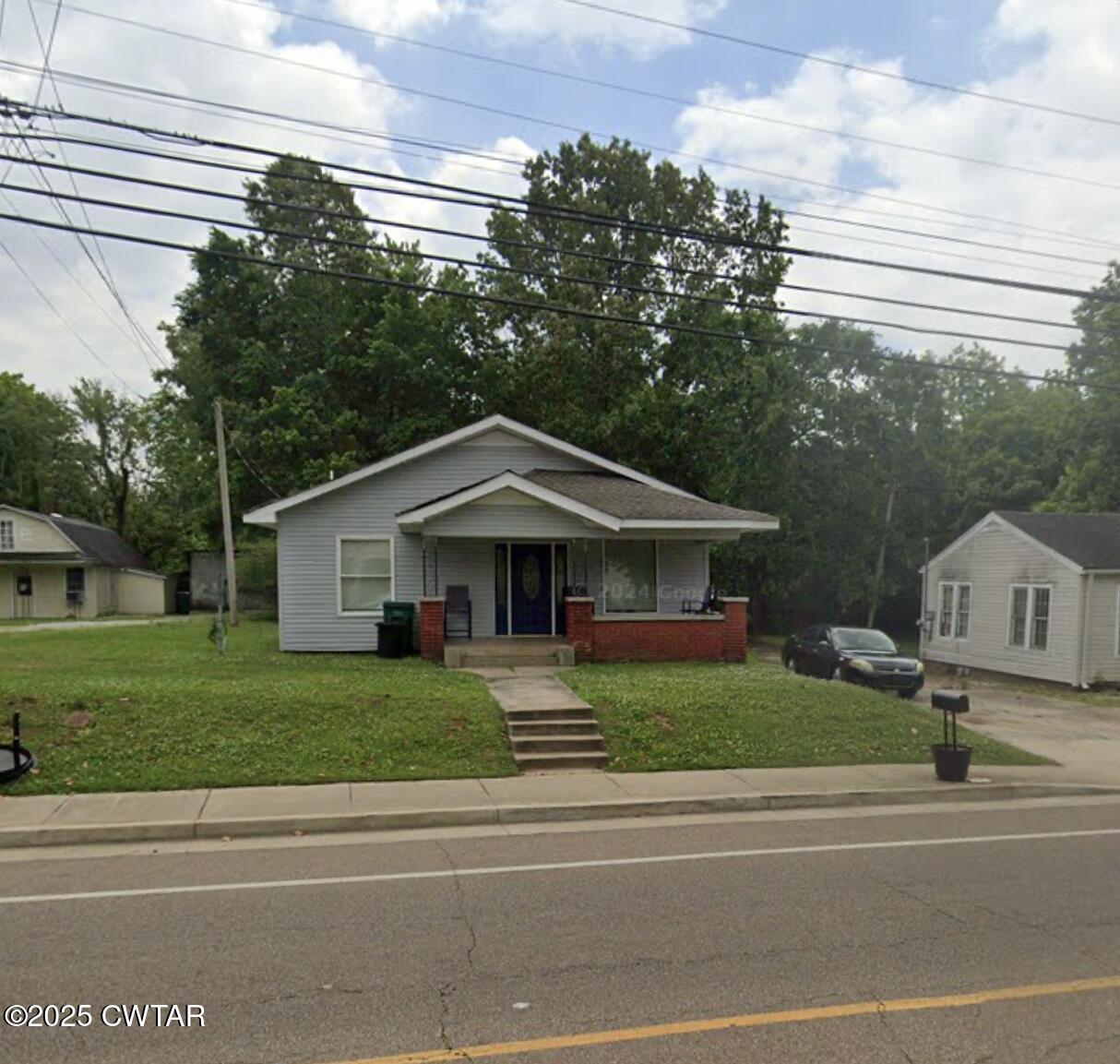 a front view of a house with a garden