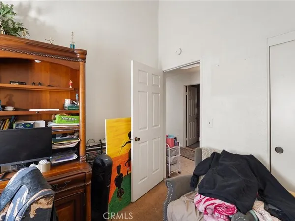 a bedroom with a bed and flat screen tv