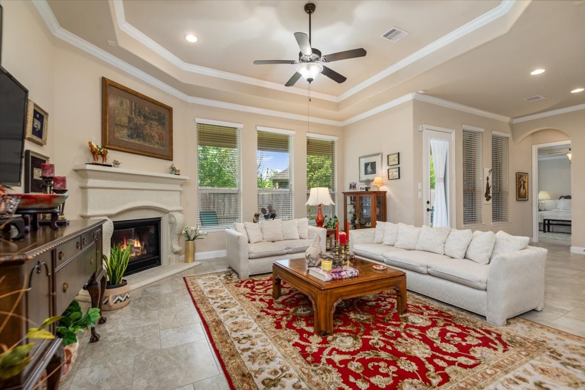 3771 Pinebrook Hollow Lane Spring, TX 77386 - Photo 16 of 50 a living room with furniture a fireplace and a flat screen tv