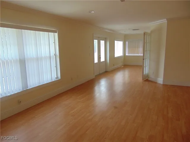 a view of wooden floor and windows in a room