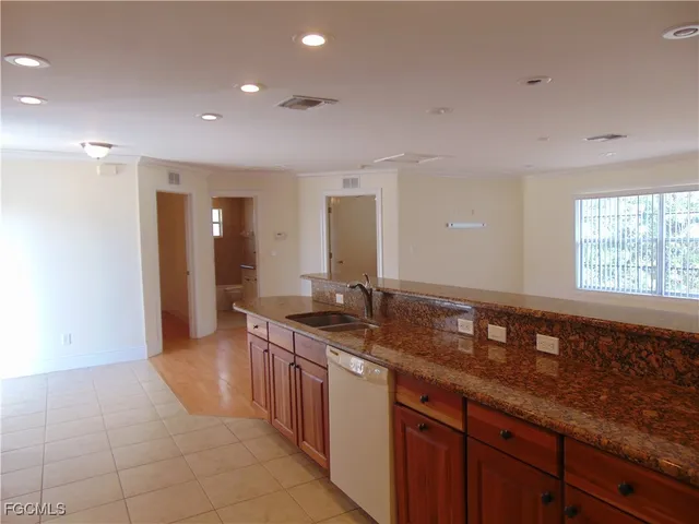 a spacious bathroom with a granite countertop sink and a mirror