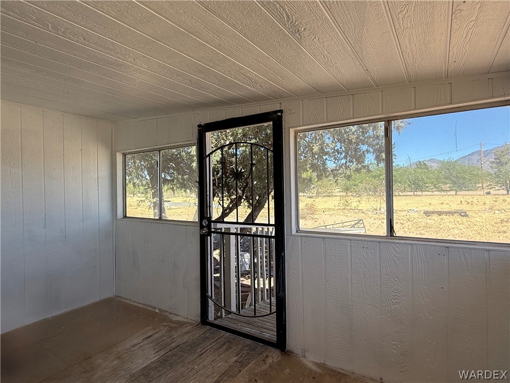 8051 7th Street Dolan Springs, AZ 86441 - Photo 8 of 65 an empty room with wooden floor and windows