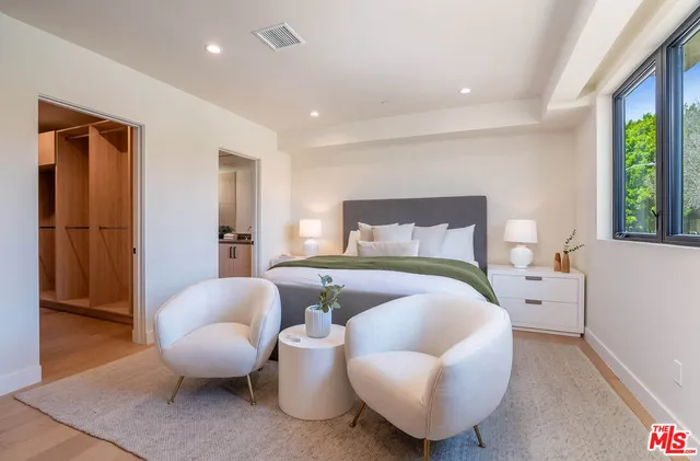 a bedroom with furniture and a window