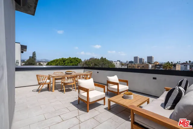 a terrace with outdoor seating and city view