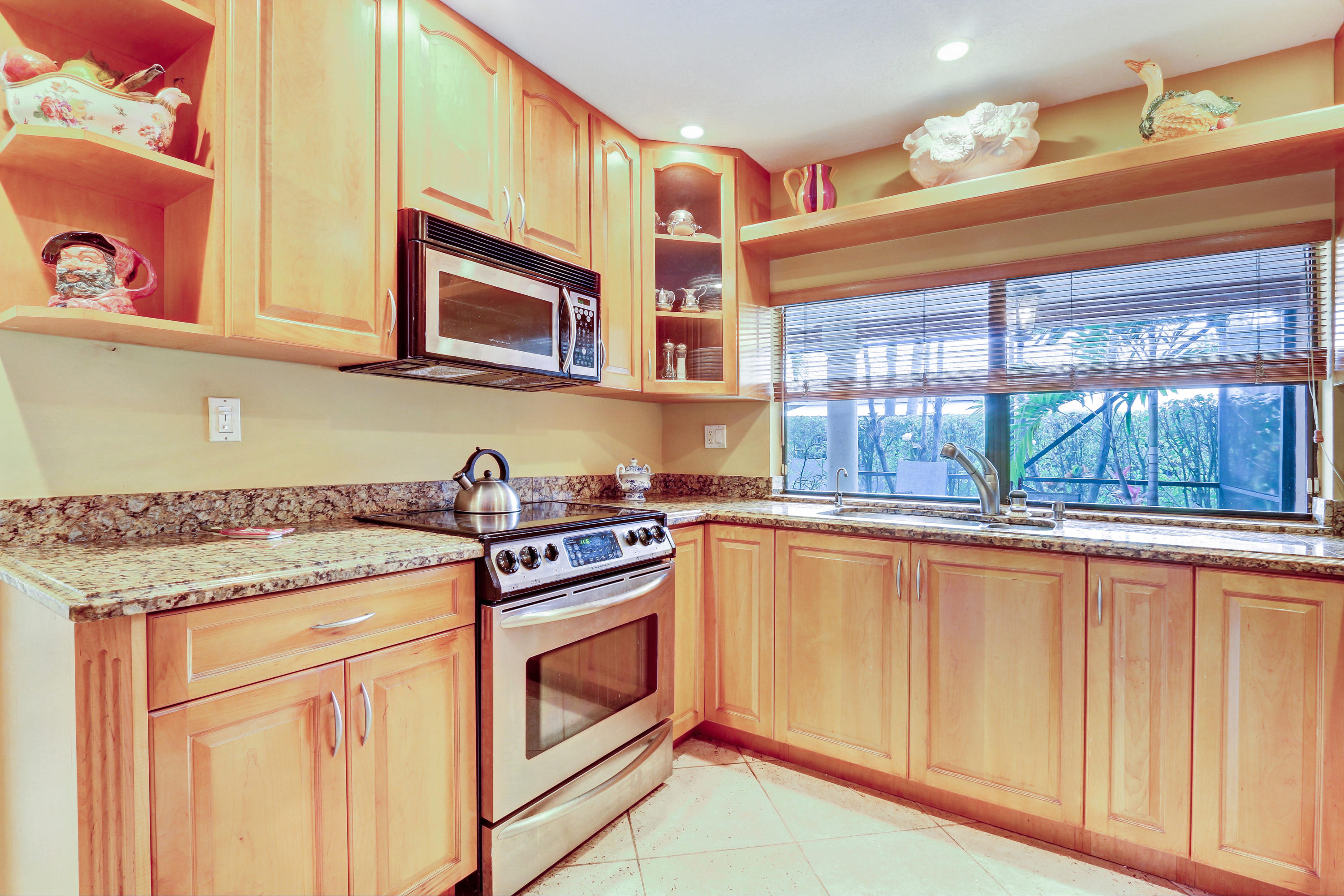 20828 Del Luna Drive Boca Raton, FL 33433 - Photo 8 of 20 a kitchen with stainless steel appliances granite countertop a stove and a microwave