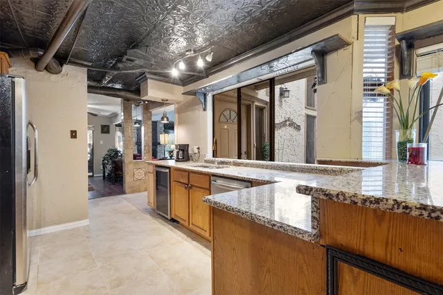 a view of a kitchen with a sink and a large window