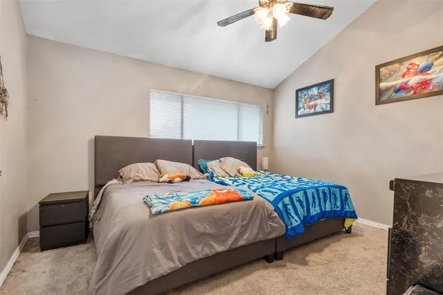 a bedroom with bed and a chandelier
