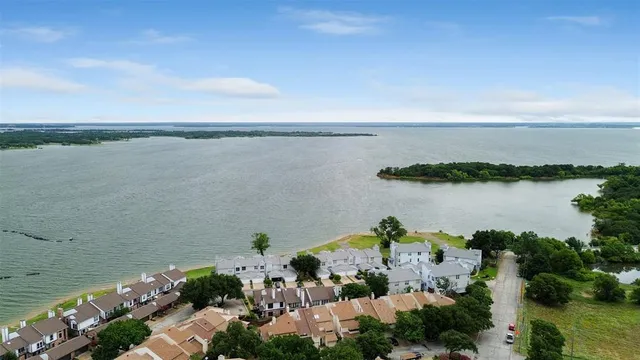 an aerial view of ocean and houses with outdoor space