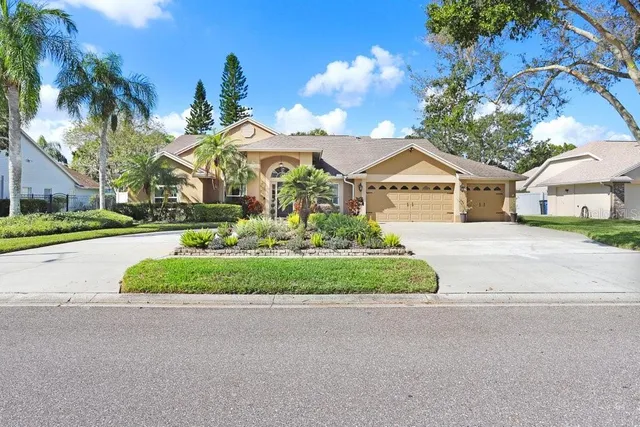 a front view of a house with a garden and pathway