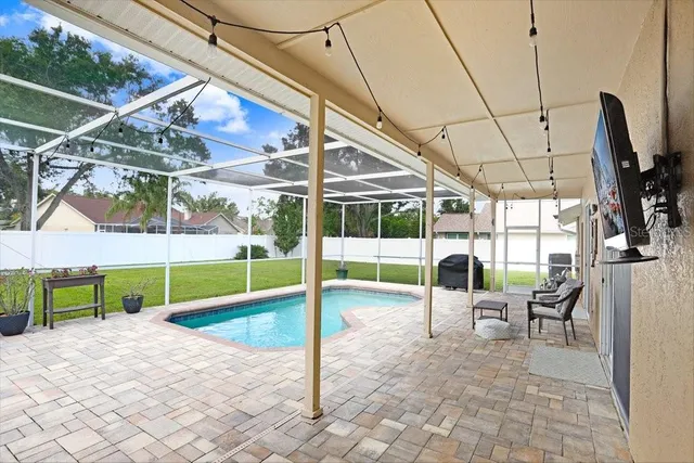 a view of yard with swimming pool and wooden fence