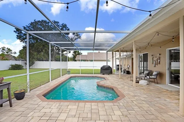 an aerial view of residential houses with outdoor space and lake view