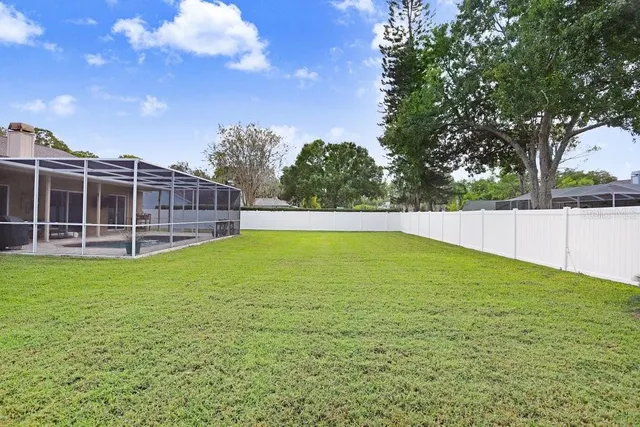 an aerial view of residential houses with outdoor space and trees