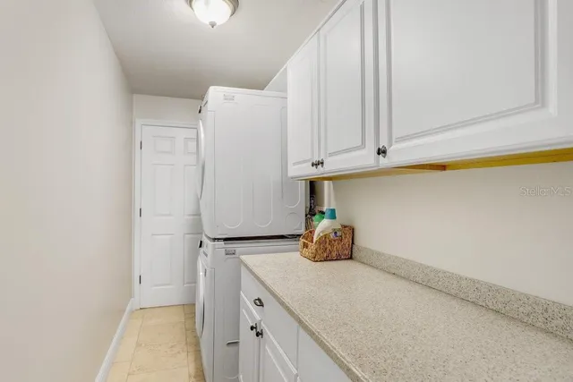 a bedroom with a bed furniture and a large window