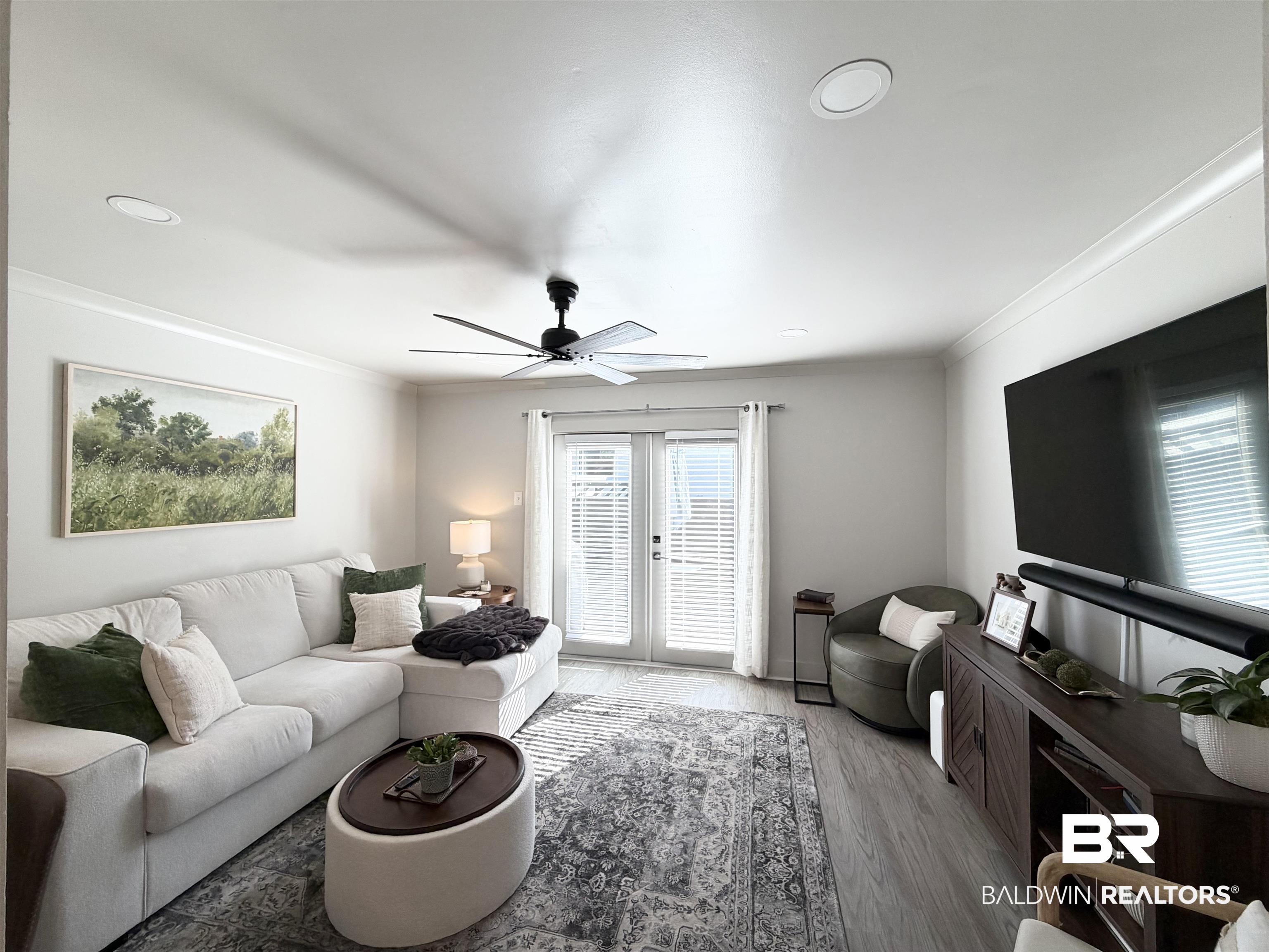 3655 Old Shell Road, Unit 211 Mobile, AL 36608 - Photo 5 of 17 Living room with french doors, ornamental molding, a ceiling fan, and wood finished floors
