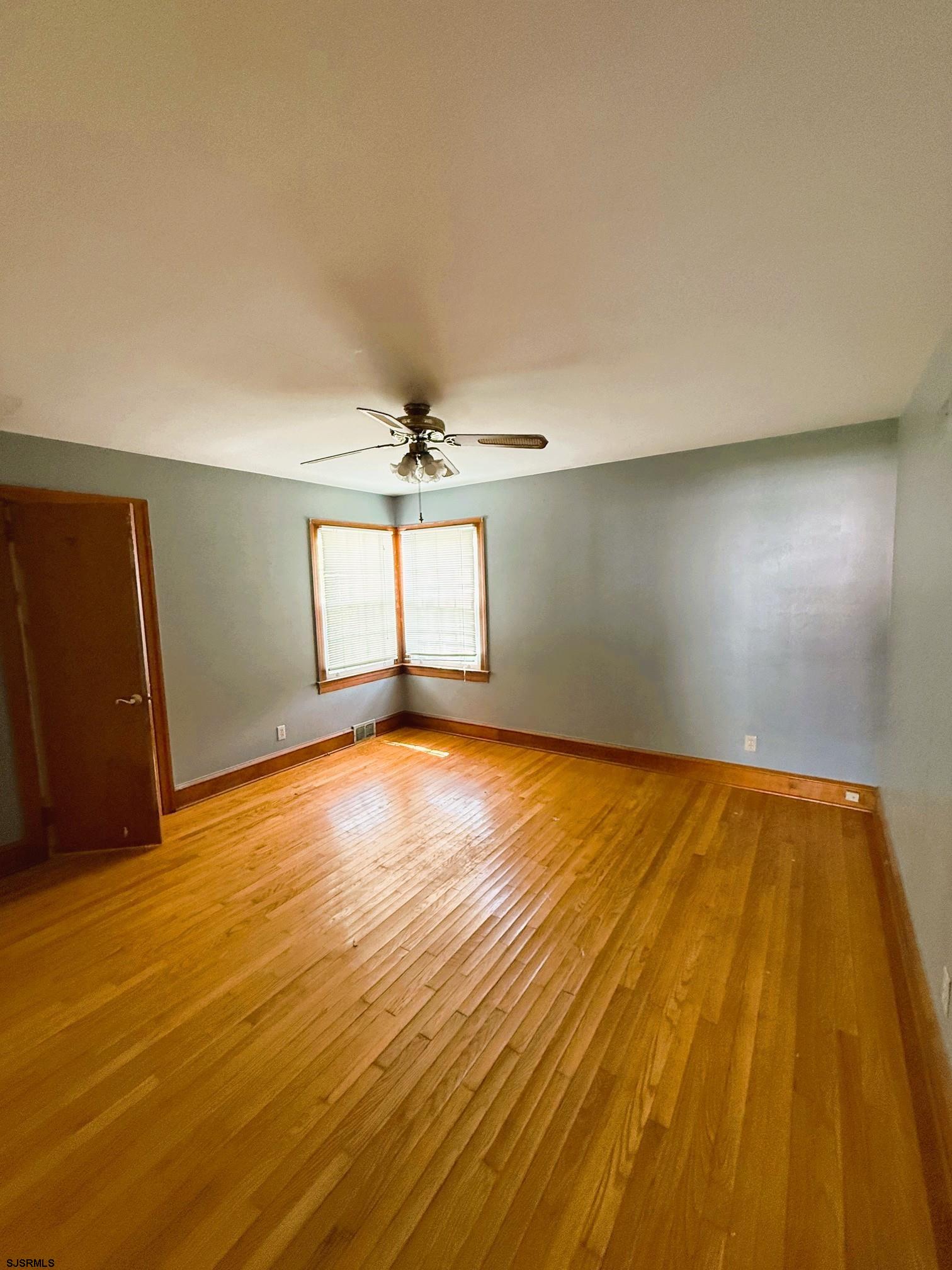 4 East Finley Road Bridgeton, NJ 08302 - Photo 13 of 33 an empty room with wooden floor and windows