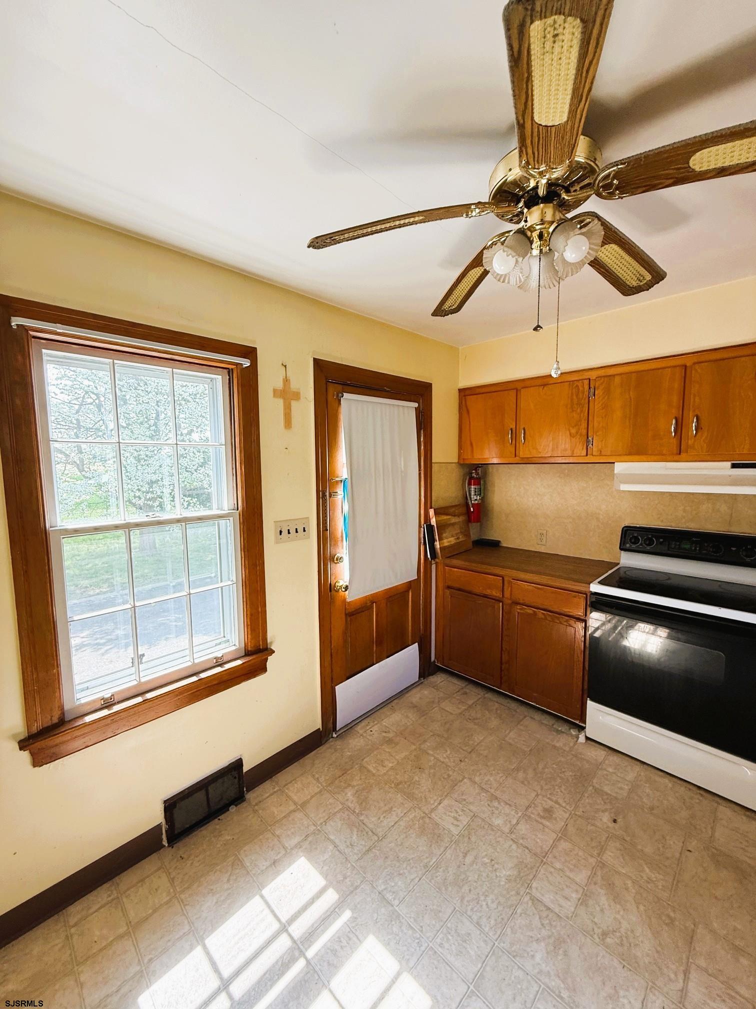4 East Finley Road Bridgeton, NJ 08302 - Photo 10 of 33 a kitchen with stainless steel appliances a stove and a chandelier
