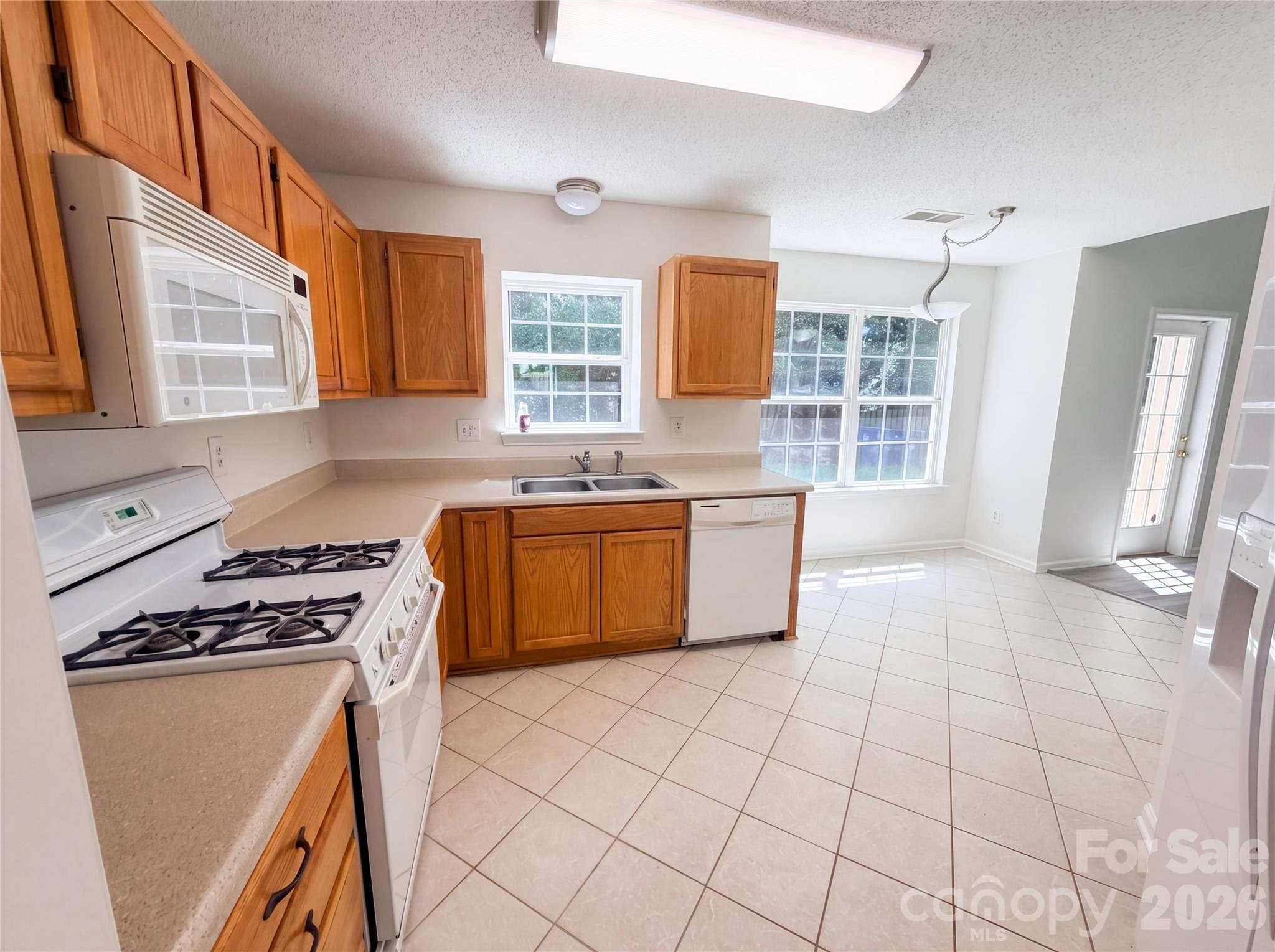 7423 Henderson Park Road Huntersville, NC 28078 - Photo 2 of 16 a kitchen with a stove a sink dishwasher and a refrigerator