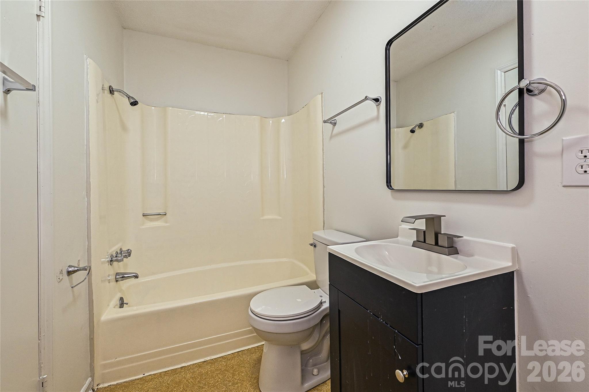 220 McDade Road, Unit 3 Forest City, NC 28043 - Photo 13 of 16 a bathroom with a sink vanity mirror and toilet