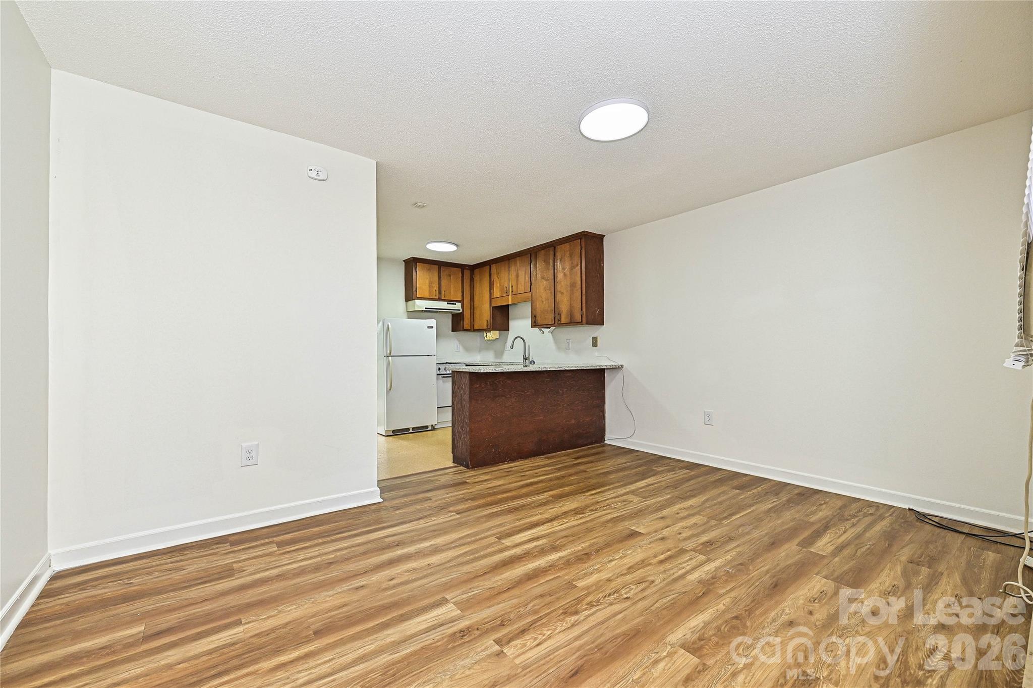 220 McDade Road, Unit 3 Forest City, NC 28043 - Photo 2 of 16 a view of a kitchen with a sink and a refrigerator