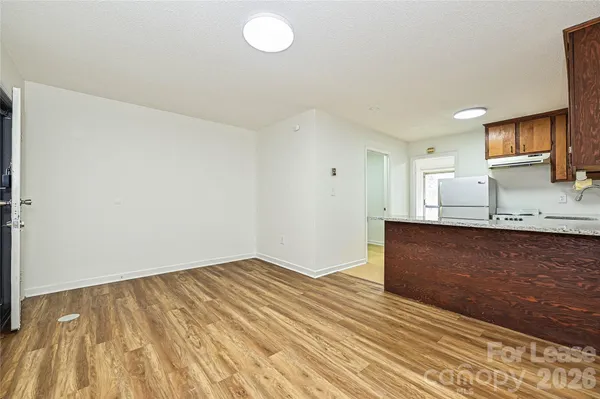 a view of kitchen and wooden floor