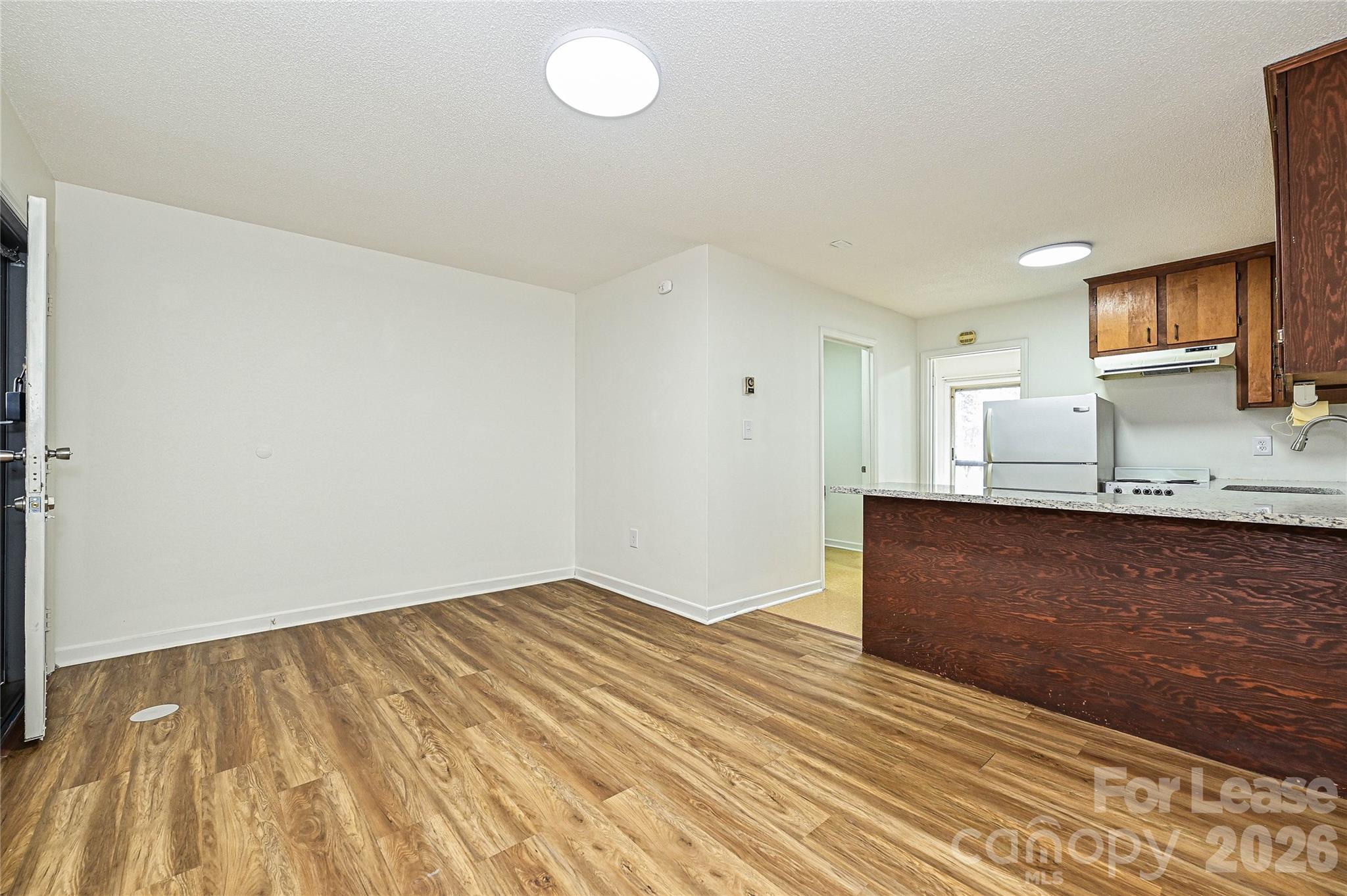 220 McDade Road, Unit 3 Forest City, NC 28043 - Photo 5 of 16 a view of kitchen and wooden floor