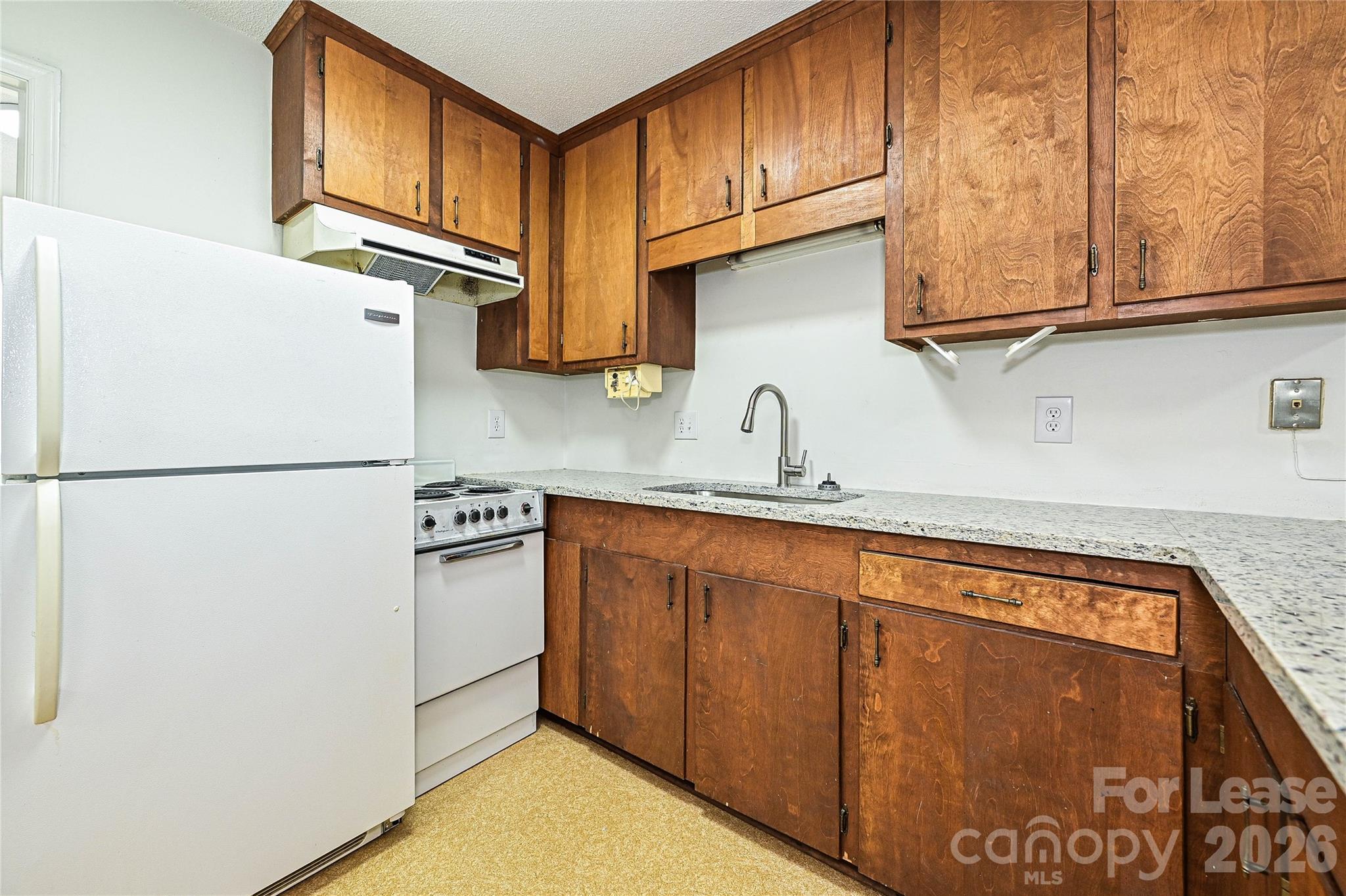 220 McDade Road, Unit 3 Forest City, NC 28043 - Photo 8 of 16 a kitchen with stainless steel appliances granite countertop a refrigerator a stove a sink and dishwasher