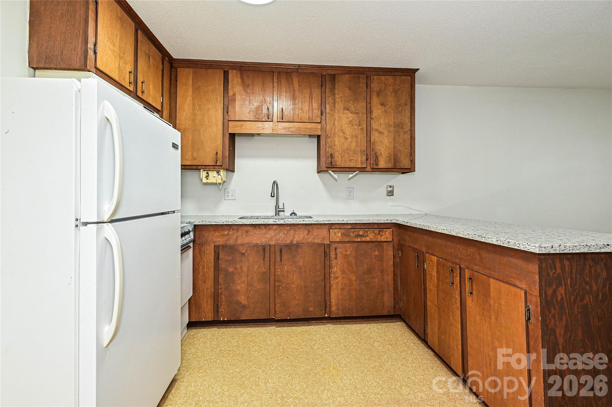 220 McDade Road, Unit 3 Forest City, NC 28043 - Photo 9 of 16 a kitchen with stainless steel appliances granite countertop a refrigerator and a sink