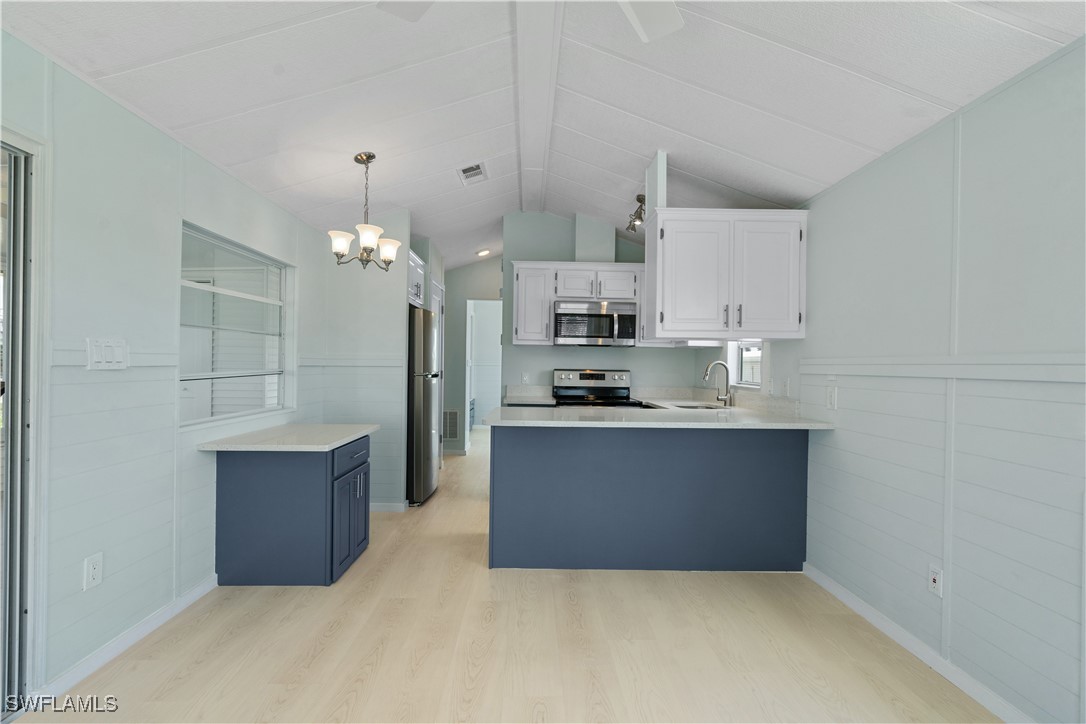 19681 Summerlin Road, Unit 234 Fort Myers, FL 33908 - Photo 11 of 41 a kitchen with kitchen island a sink stainless steel appliances and cabinets