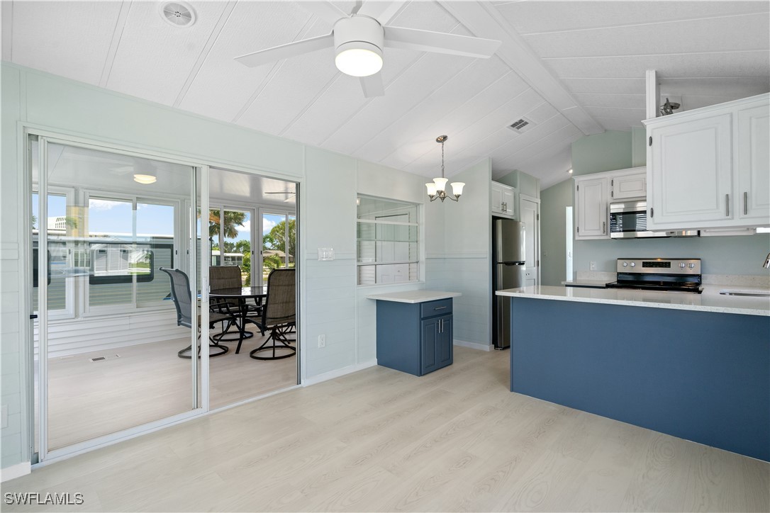 19681 Summerlin Road, Unit 234 Fort Myers, FL 33908 - Photo 12 of 41 a kitchen with stainless steel appliances kitchen island granite countertop a refrigerator and cabinets