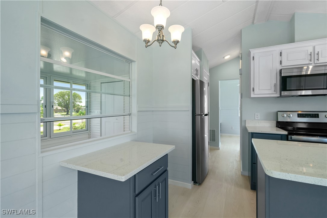 19681 Summerlin Road, Unit 234 Fort Myers, FL 33908 - Photo 15 of 41 a kitchen with stainless steel appliances a sink a microwave a refrigerator and a stove