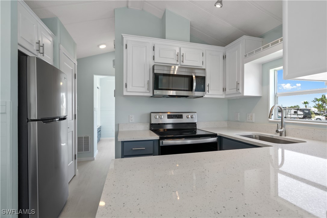 19681 Summerlin Road, Unit 234 Fort Myers, FL 33908 - Photo 17 of 41 a kitchen with stainless steel appliances granite countertop a refrigerator a stove top oven a sink and dishwasher