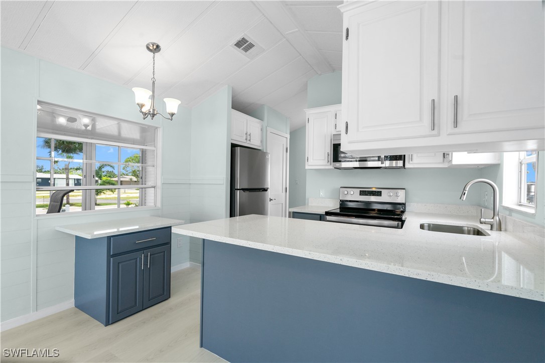19681 Summerlin Road, Unit 234 Fort Myers, FL 33908 - Photo 18 of 41 a kitchen with stainless steel appliances a sink stove and refrigerator