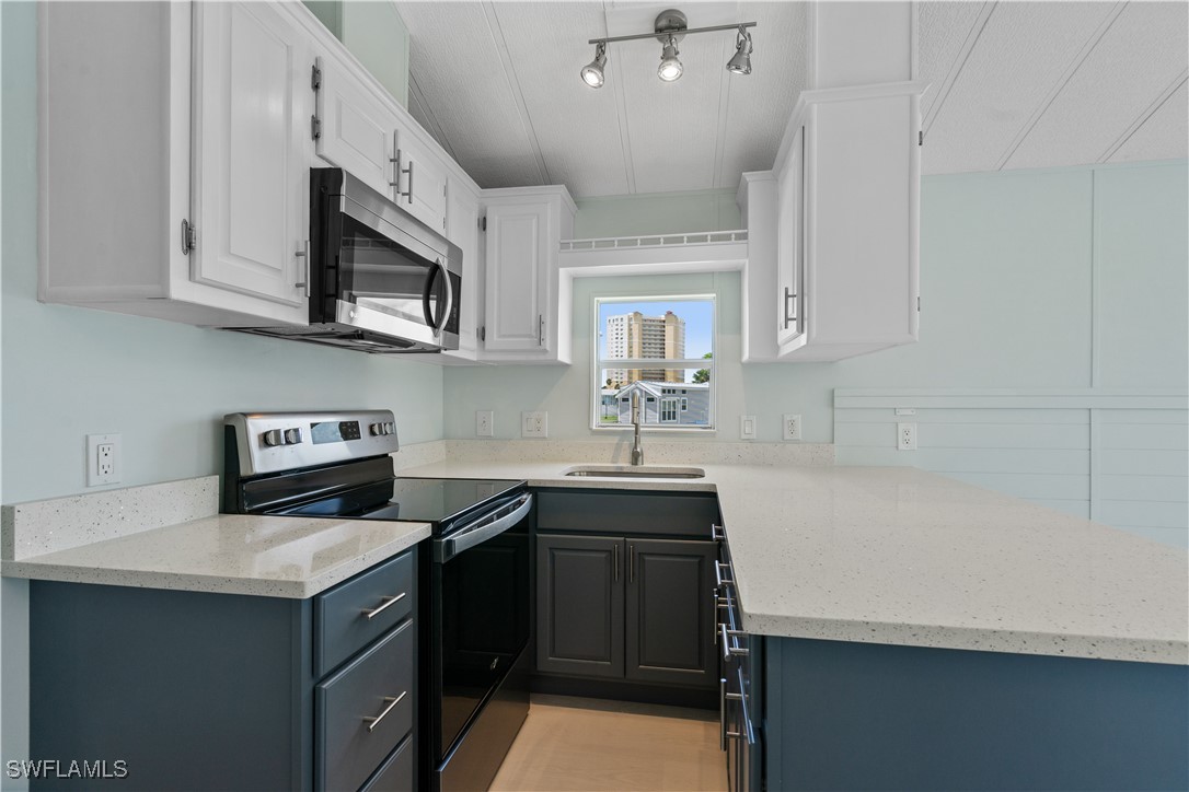 19681 Summerlin Road, Unit 234 Fort Myers, FL 33908 - Photo 19 of 41 a kitchen that has a sink and a stove top oven