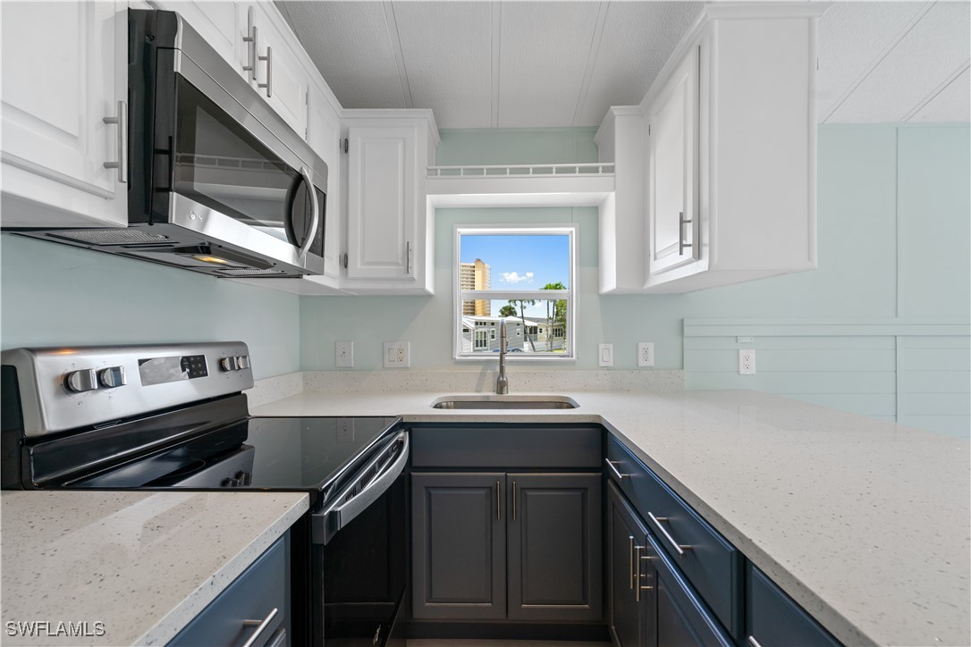 19681 Summerlin Road, Unit 234 Fort Myers, FL 33908 - Photo 20 of 41 a kitchen with stainless steel appliances a sink a stove and cabinets
