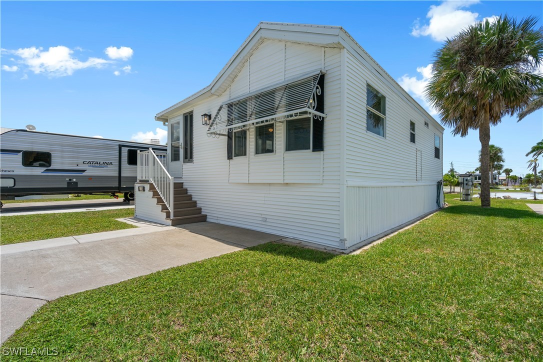 19681 Summerlin Road, Unit 234 Fort Myers, FL 33908 - Photo 2 of 41 a view of a house with a backyard