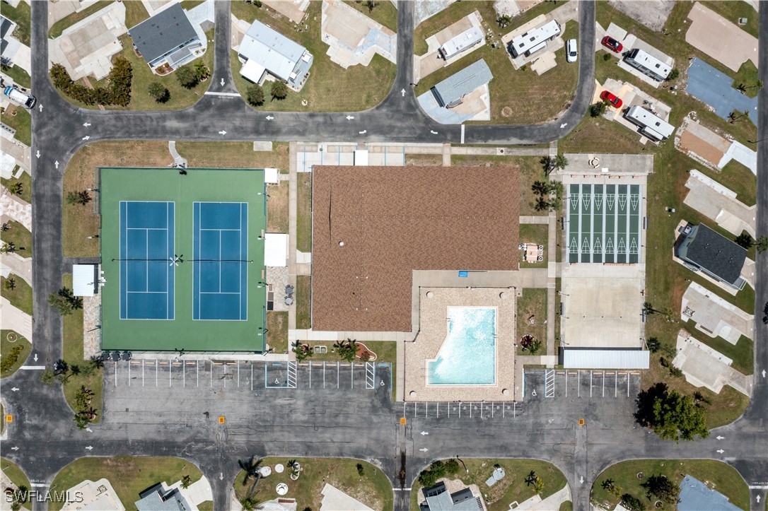 19681 Summerlin Road, Unit 234 Fort Myers, FL 33908 - Photo 30 of 41 a view of a brick house with a large tree and many windows