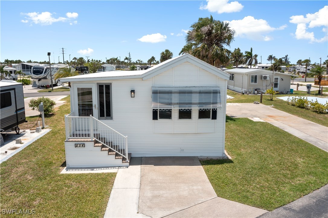 19681 Summerlin Road, Unit 234 Fort Myers, FL 33908 - Photo 39 of 41 a front view of a house with a yard