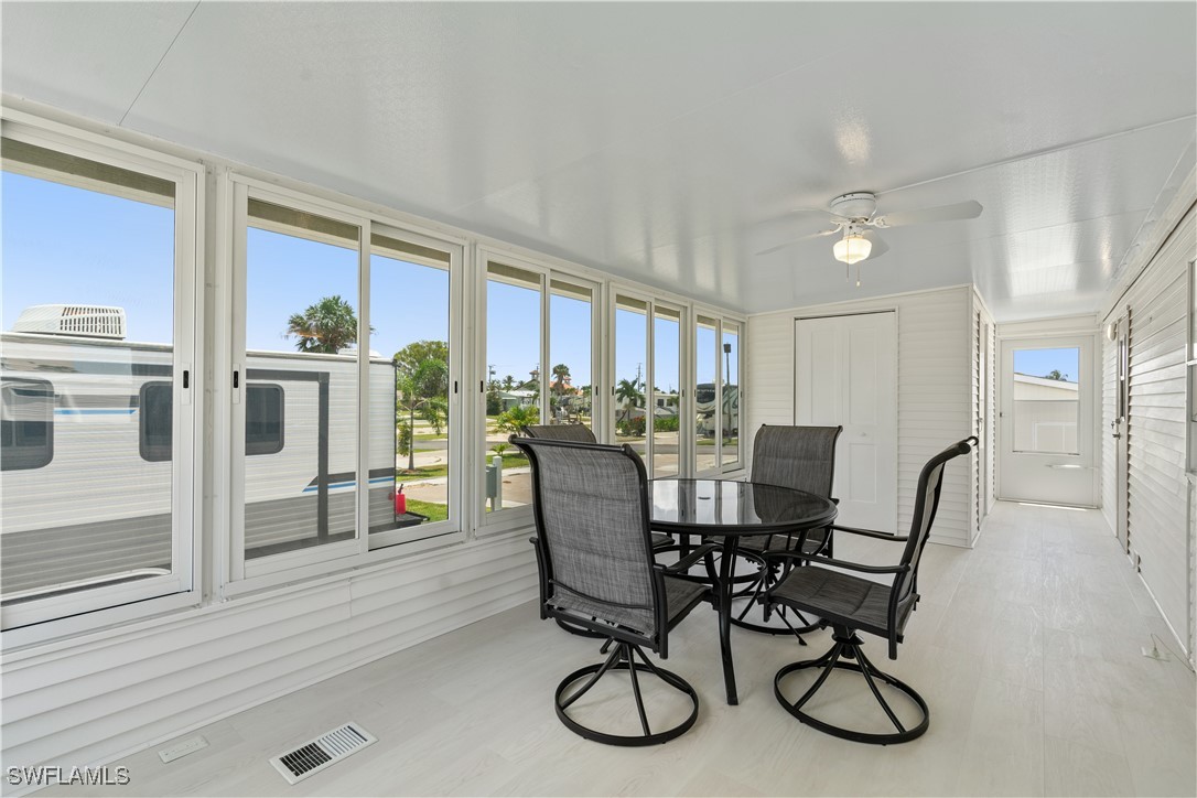 19681 Summerlin Road, Unit 234 Fort Myers, FL 33908 - Photo 7 of 41 a view of a dining room with furniture large window and wooden floor
